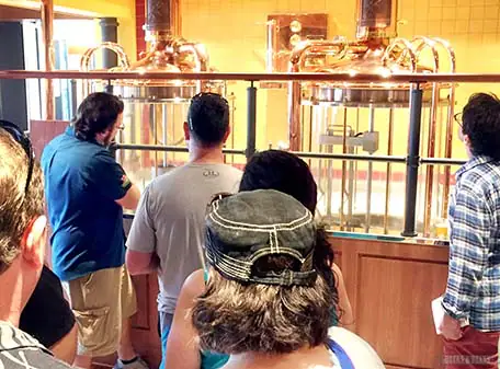 Several guests admiring the glass brew house at the entrance of Redfrog Pub and Brewery