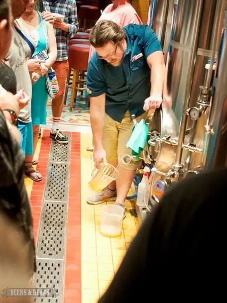 Brewmaster Colin Presby pouring fresh IPA straight into pitcher from the serving tank