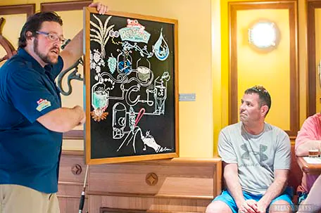Brewmaster Colin Presby with chalkboard illustration explains the brewing process during the tasting tour