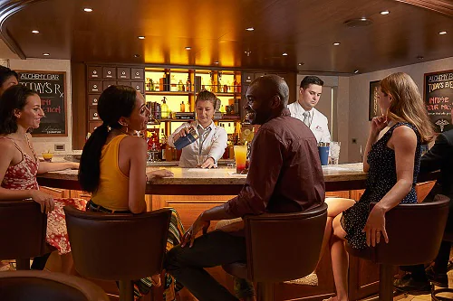 bartenders tending to a crowd at alchemy bar