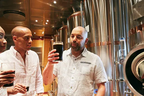friends looking a freshly brewed beer from the redfrog pub and brewery