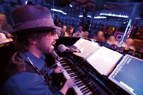 pianist singing at piano bar