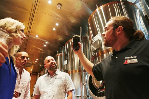 brewmaster examining fresh beer made onboard carnival vista