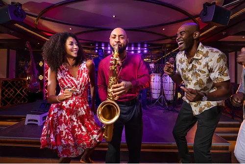 trumpet player playing live music at the havana bar as guests dance along