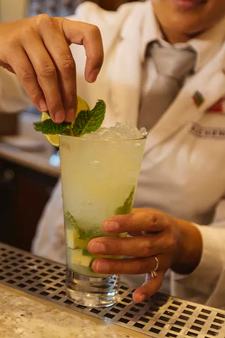 bartender serving a drink at alchemy bar