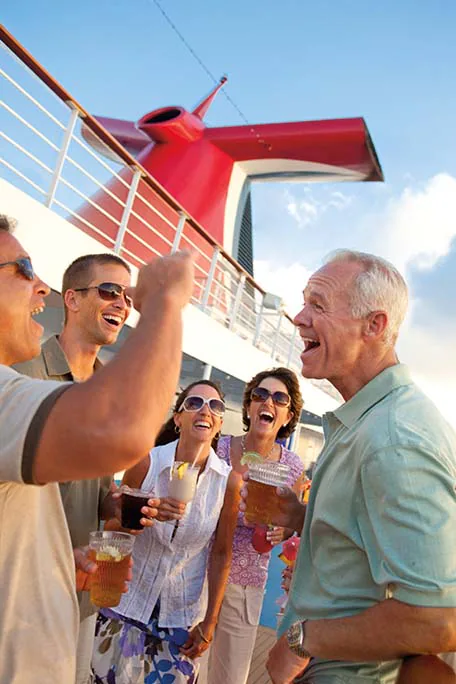 group of people standing by a rail with drinks
