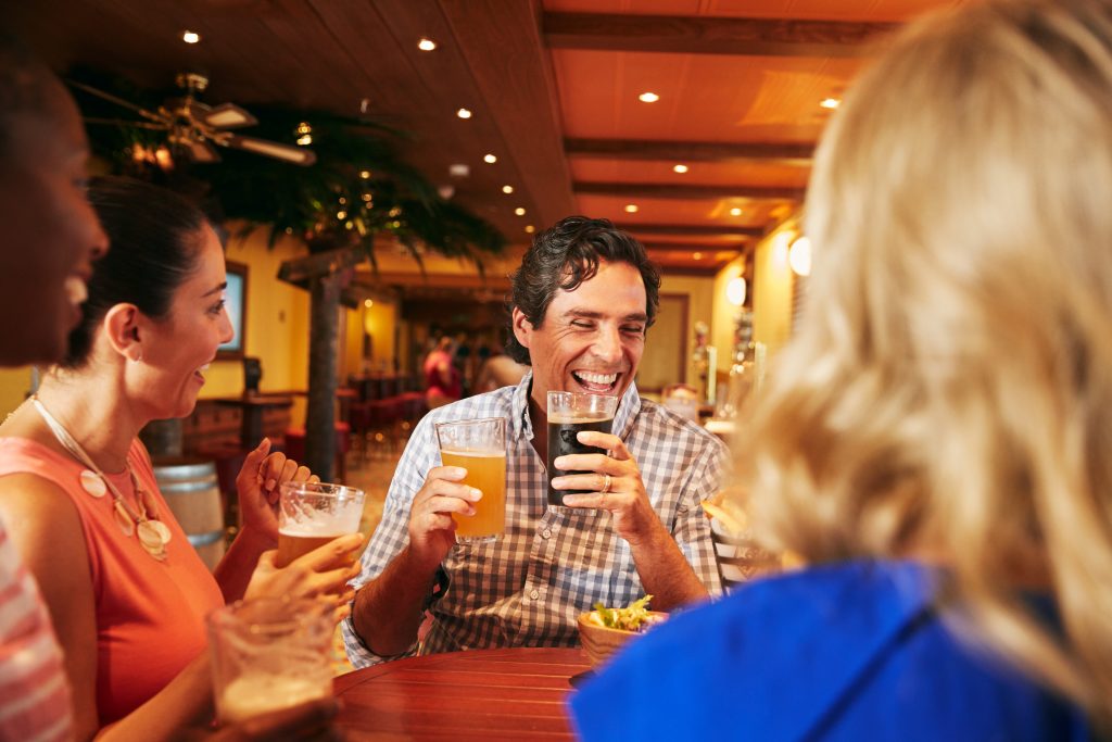 Carnival guests enjoying drinks at the Red Frog Pub